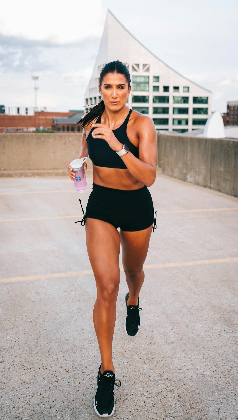 a woman in a sports bra top and shorts running