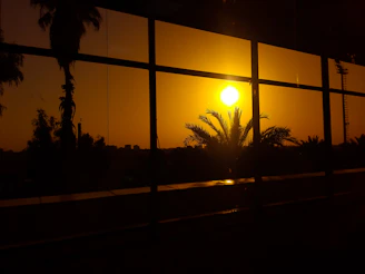 A vibrant acrylic photo frame showcasing a sunset beach scene with LED backlighting.