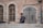 a man standing in front of a brick building