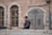 a man standing in front of a brick building