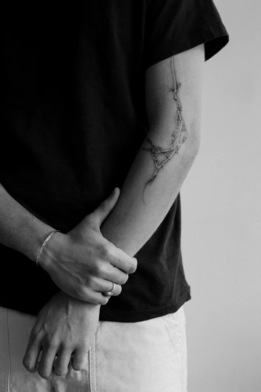 Intricate fine line arm tattoo