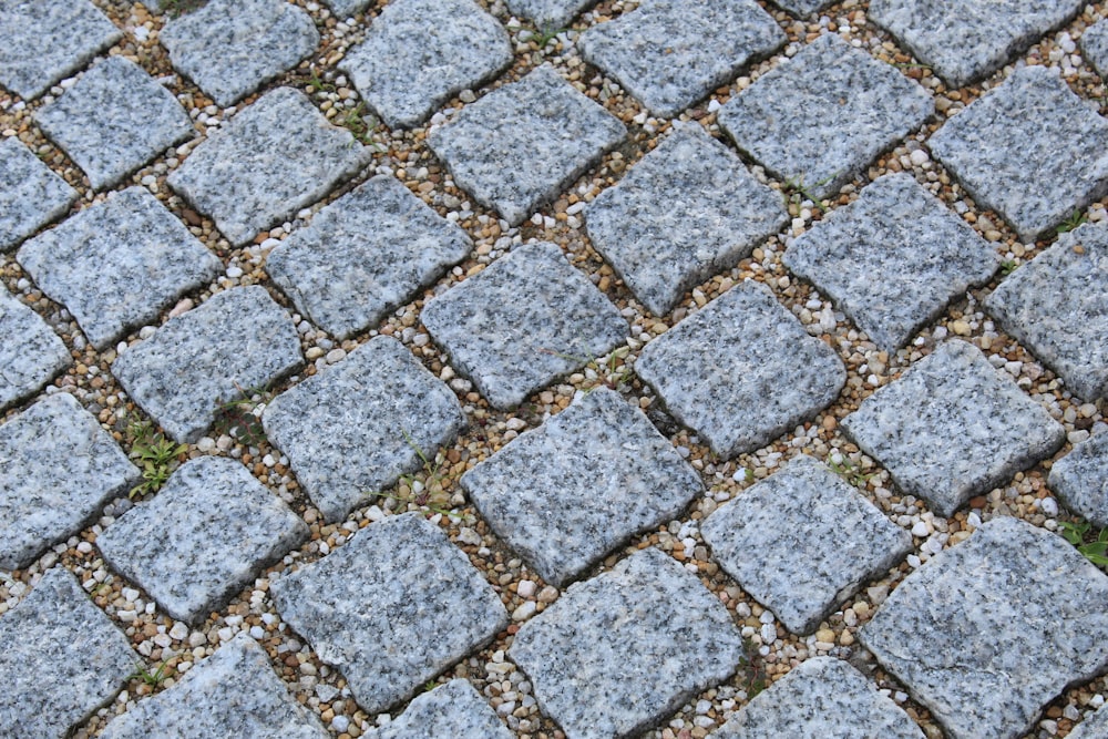 a close up of a stone walkway with grass