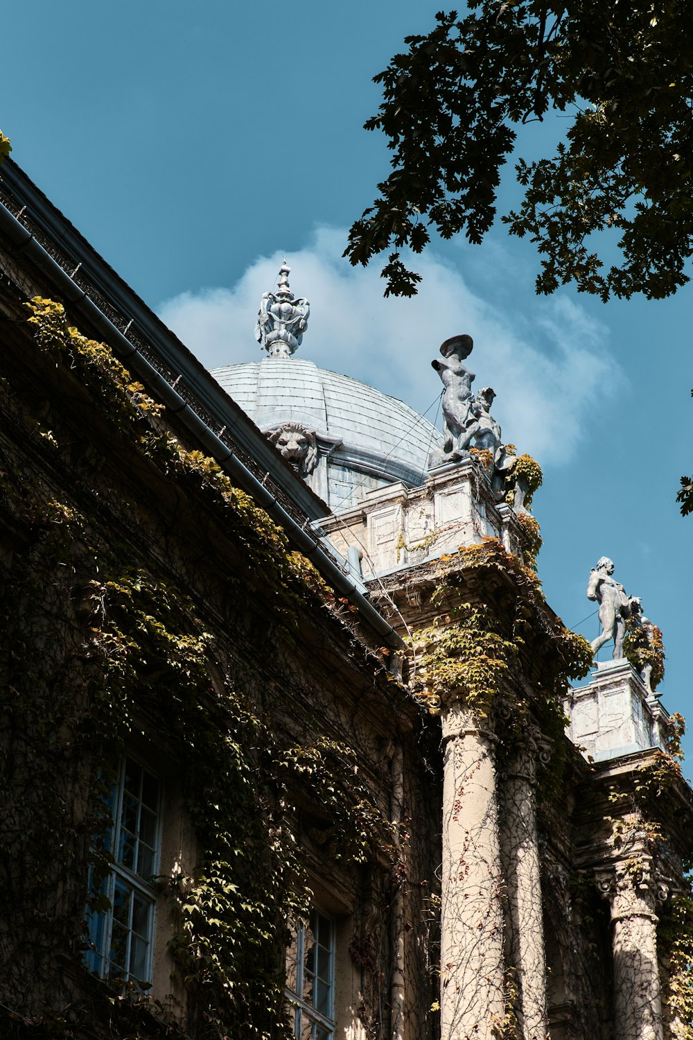 a tall building with statues on top of it