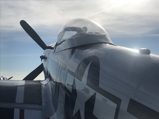 A close-up of a vintage airplane ready for takeoff on a sunny day.