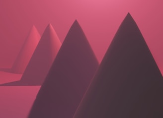 a group of mountains with a pink sky in the background