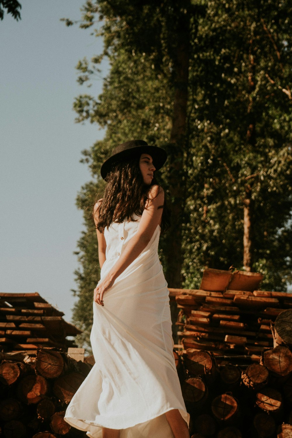 a woman in a white dress and a black hat