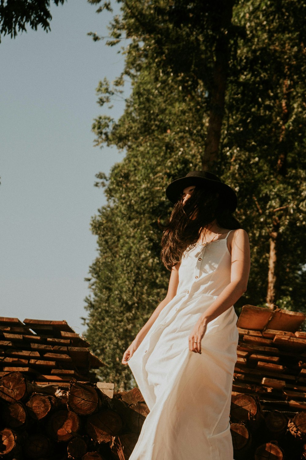 a woman in a white dress and black hat