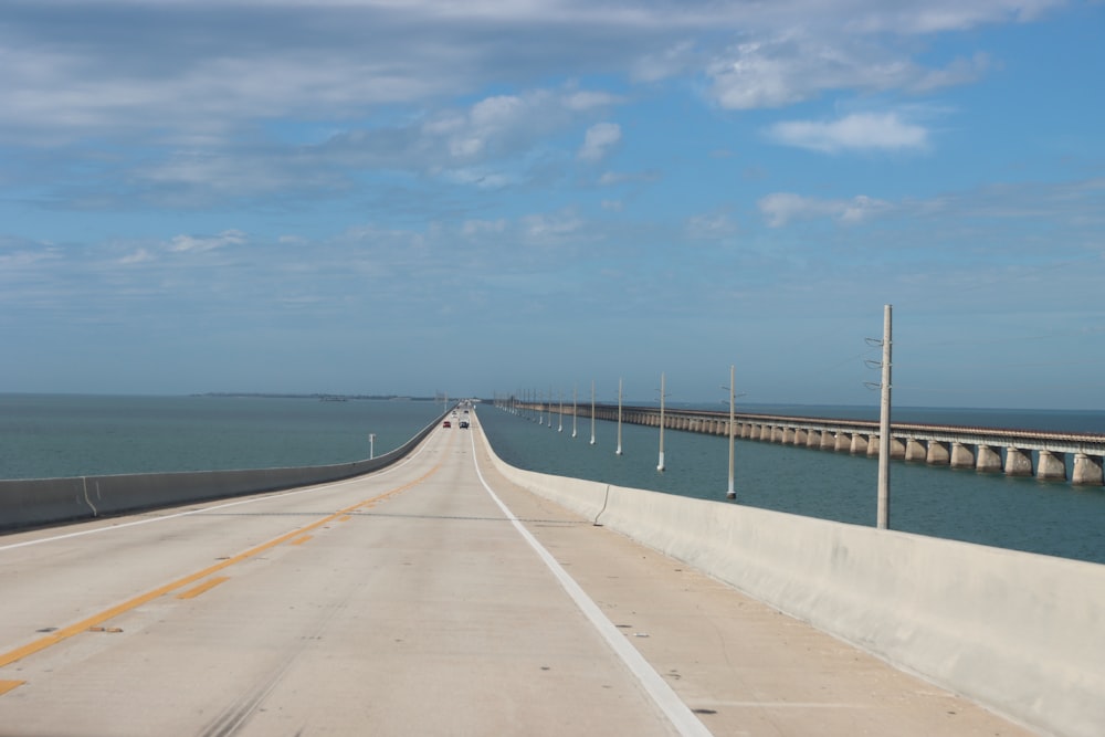 a long stretch of highway next to a large body of water