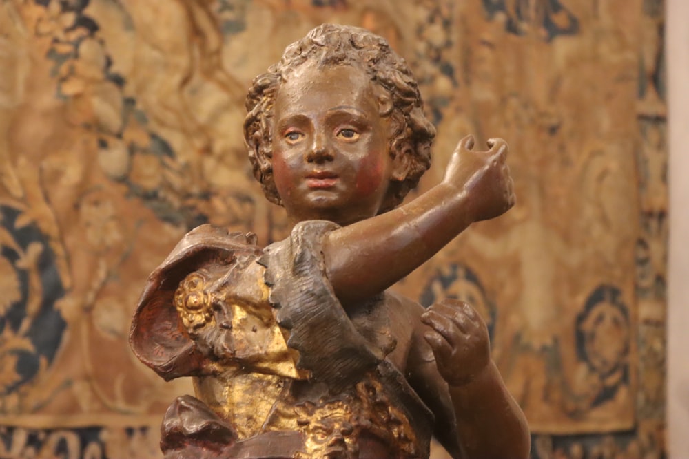 a statue of a little girl holding a bird