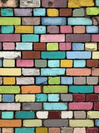 a multicolored brick wall is shown in this image