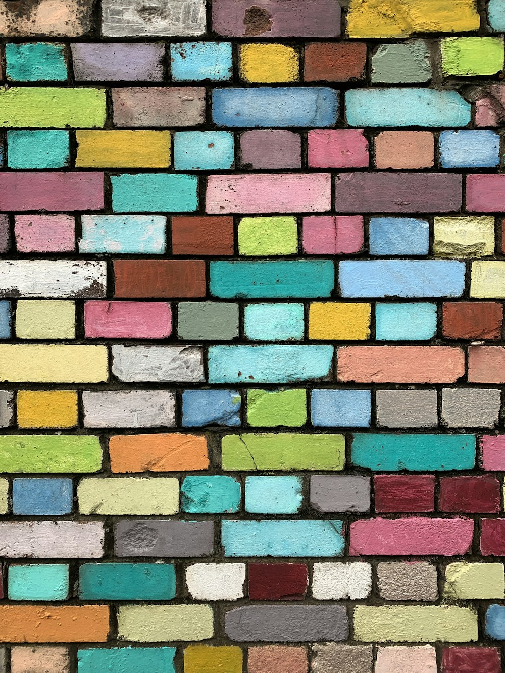 a multicolored brick wall is shown in this image