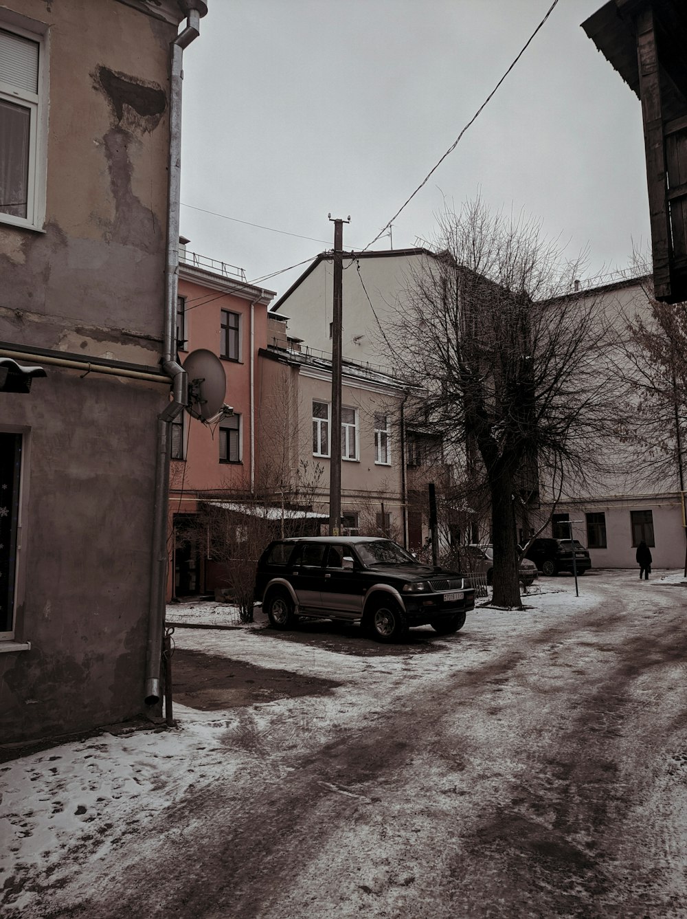 a car is parked on a snowy street