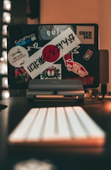 A cozy workspace with colorful custom stickers and vinyl heat transfer designs laid out.