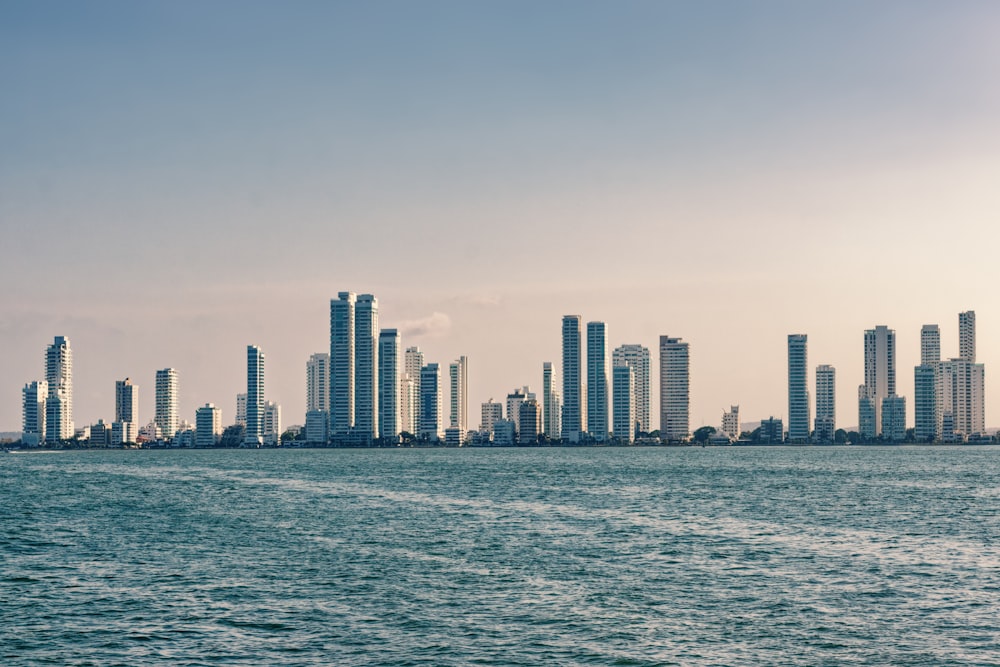 a large body of water with a city in the background