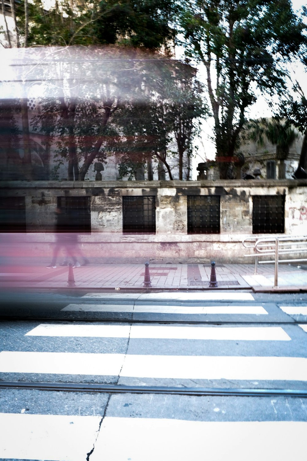 a blurry photo of a crosswalk with a building in the background