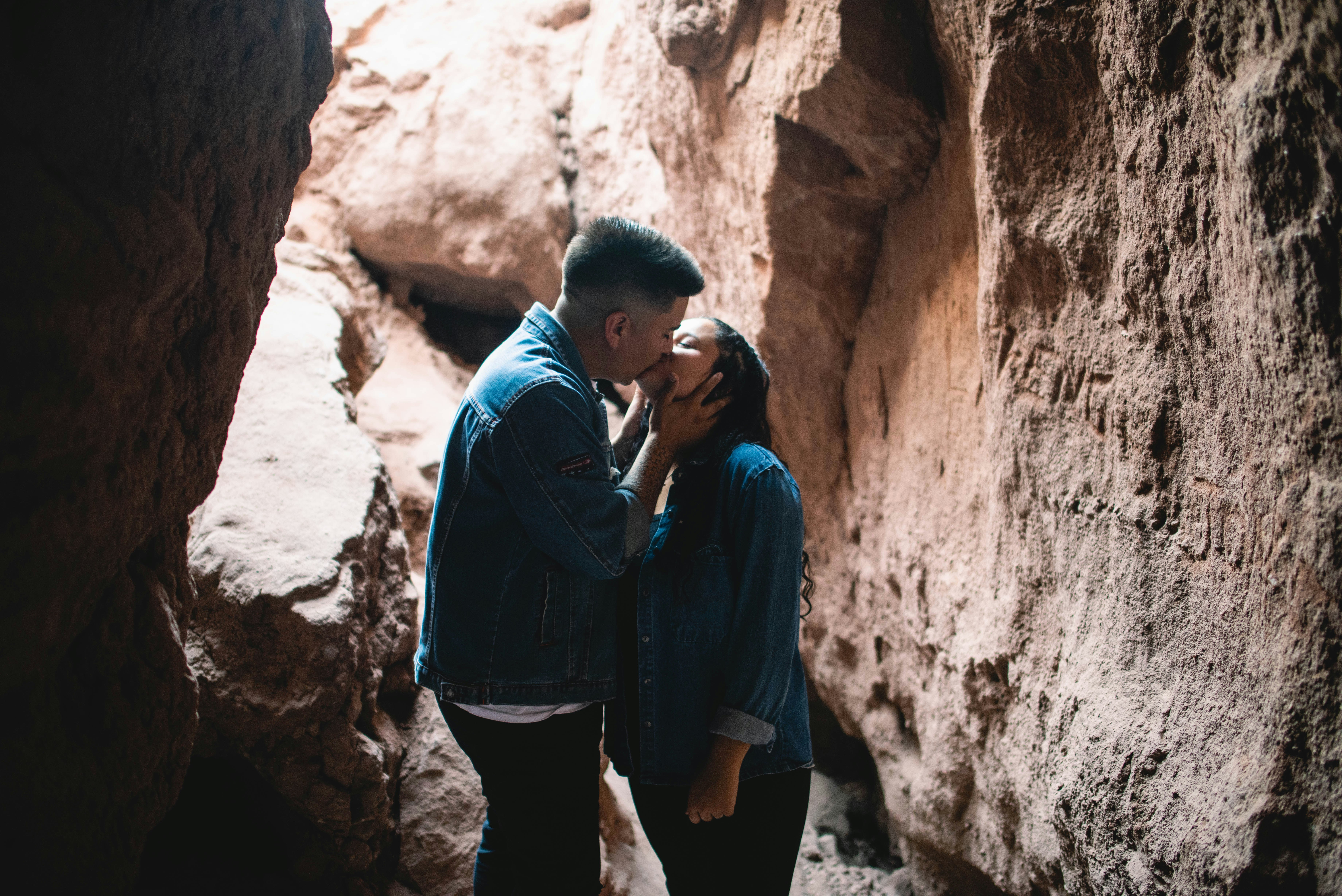 a man and a woman standing in a cave