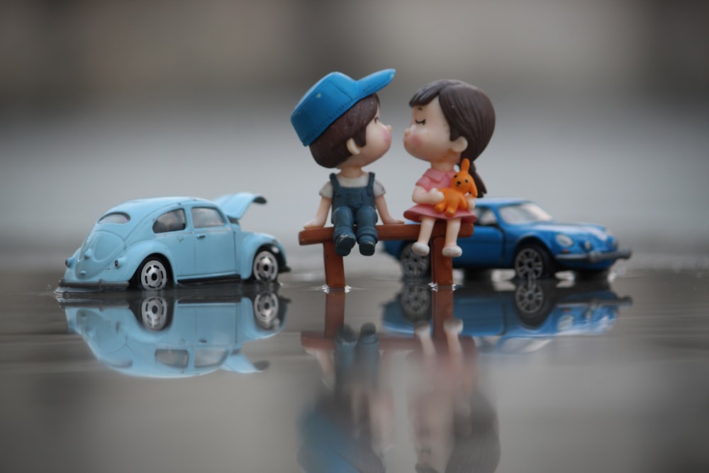 a couple of figurines sitting on top of a table