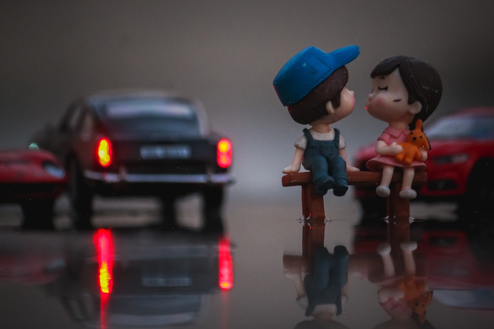 a couple of figurines sitting on top of a table