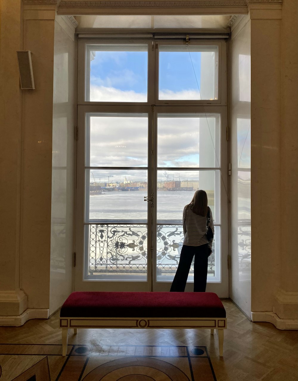 a woman standing in front of a large window