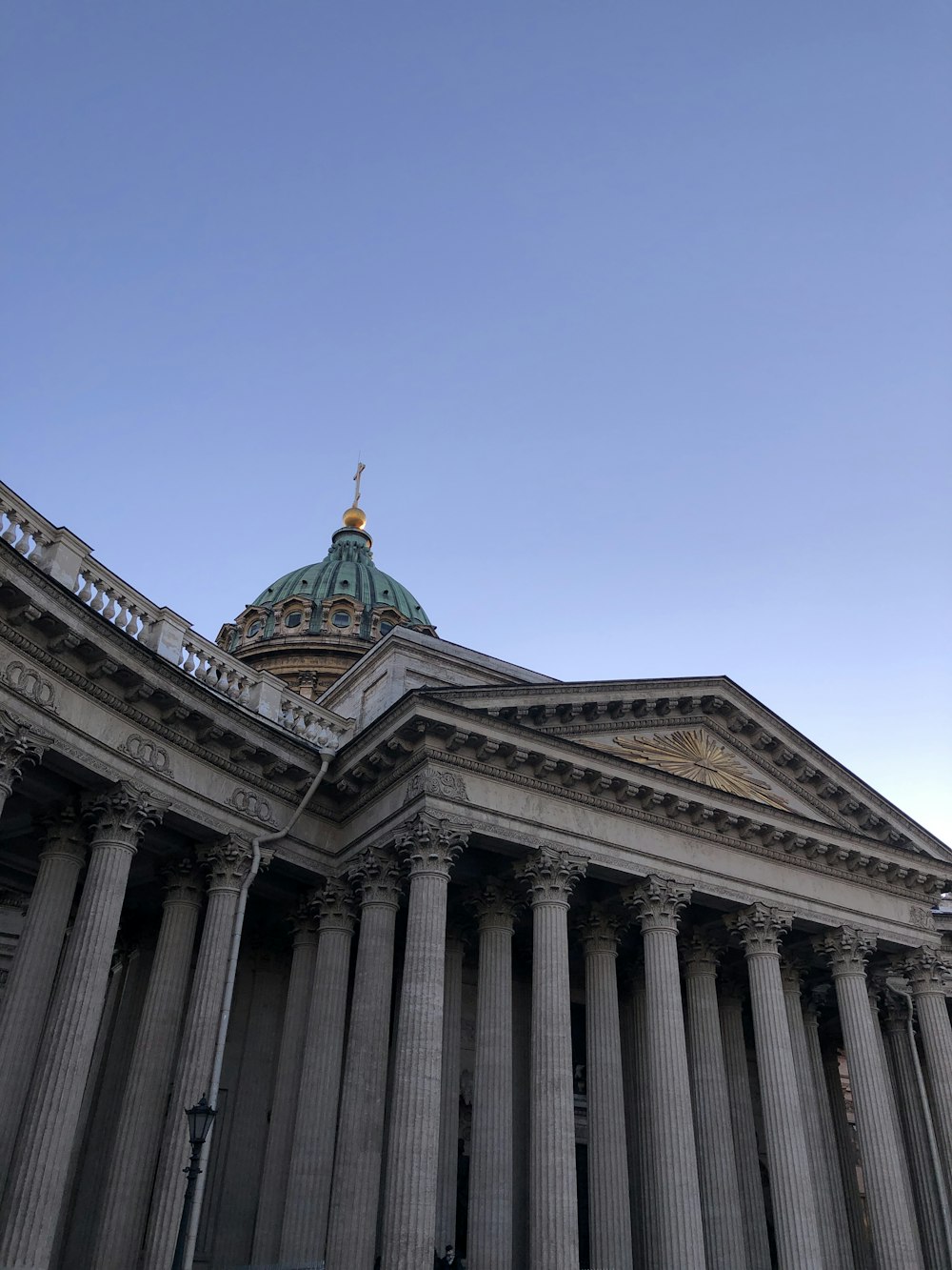 a tall building with columns and a dome on top