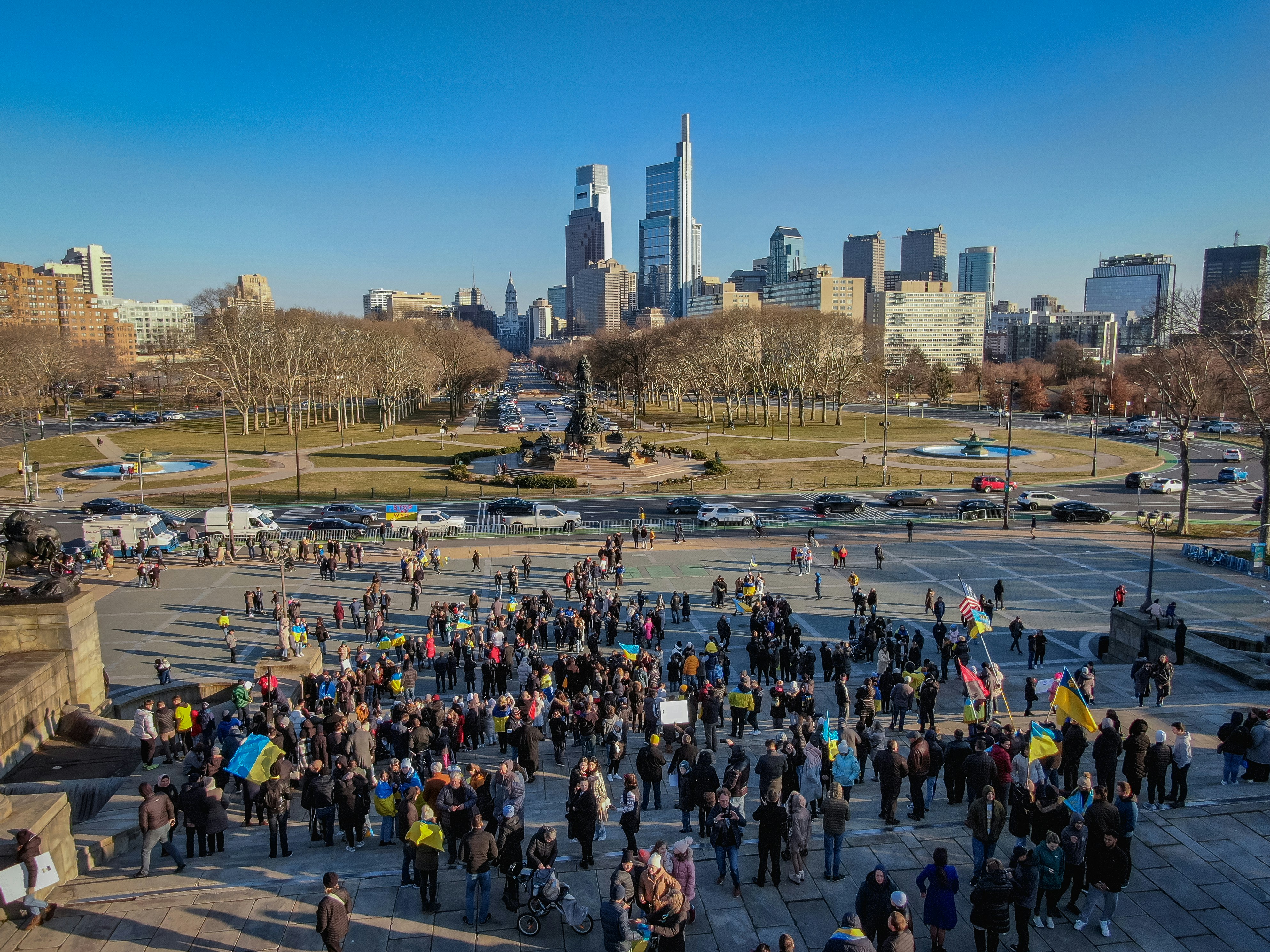 a large group of people standing in a parking lot