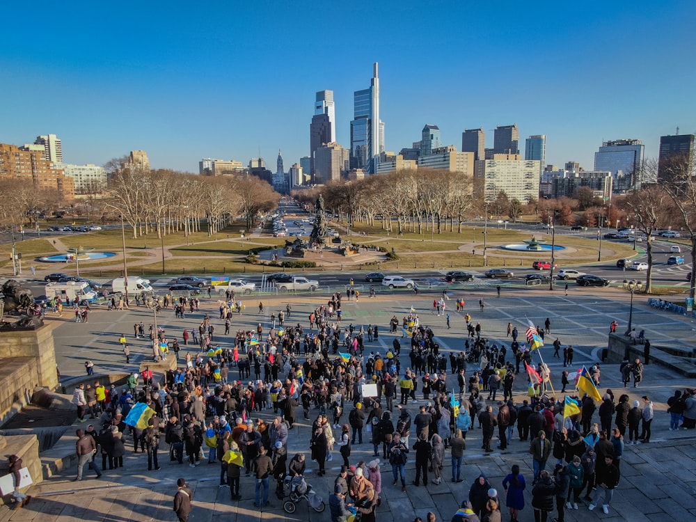 a large group of people standing in a parking lot