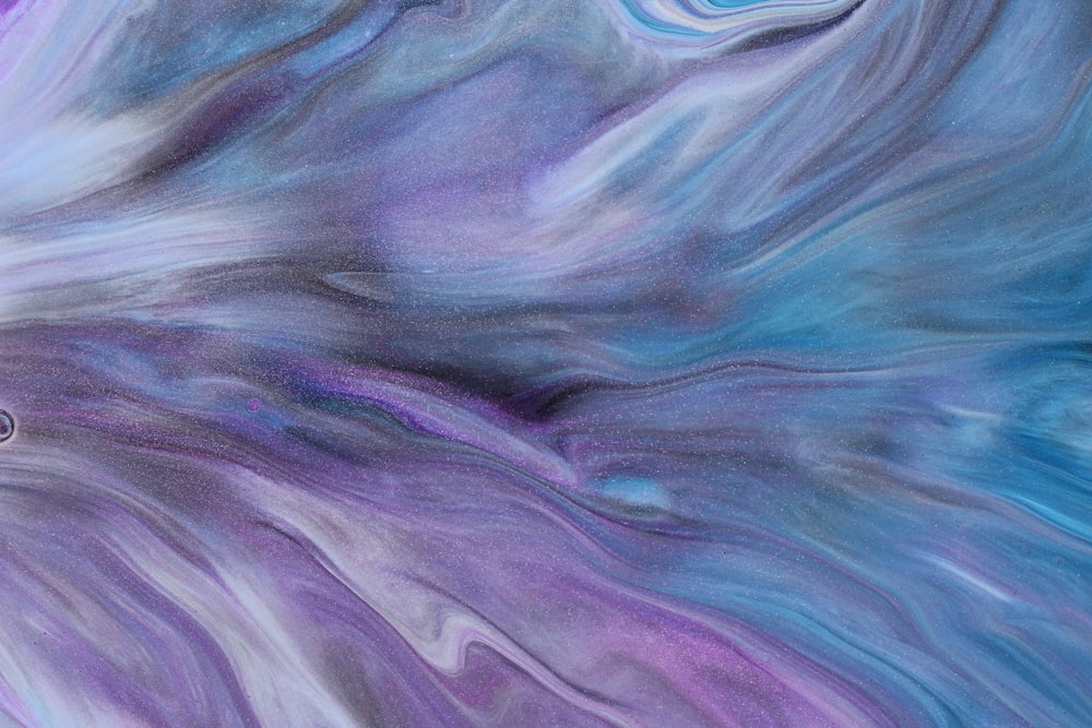 an abstract painting with blue, purple, and white colors
