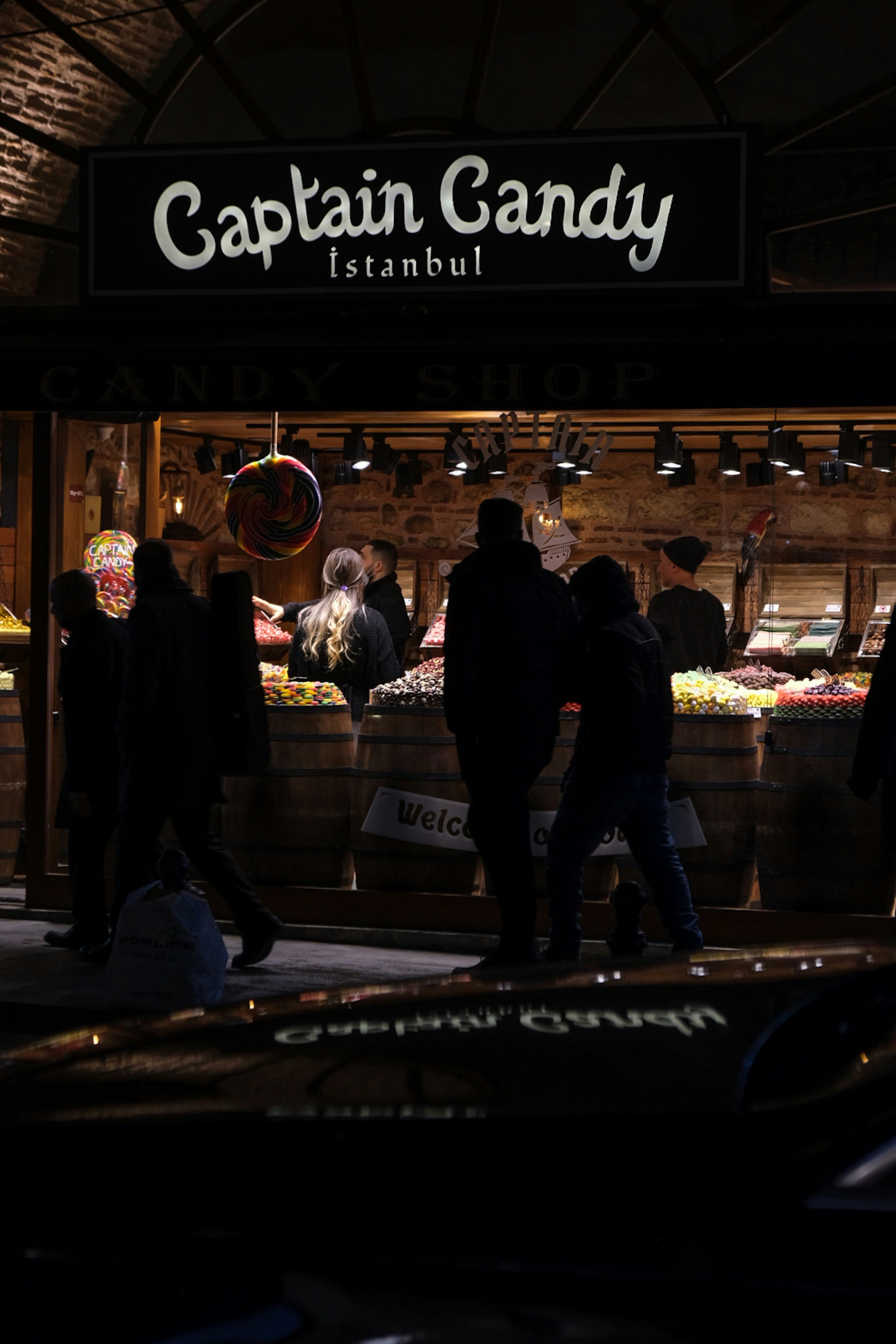 a group of people standing outside of a store