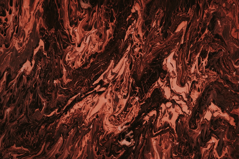 a close up of a red and black marble