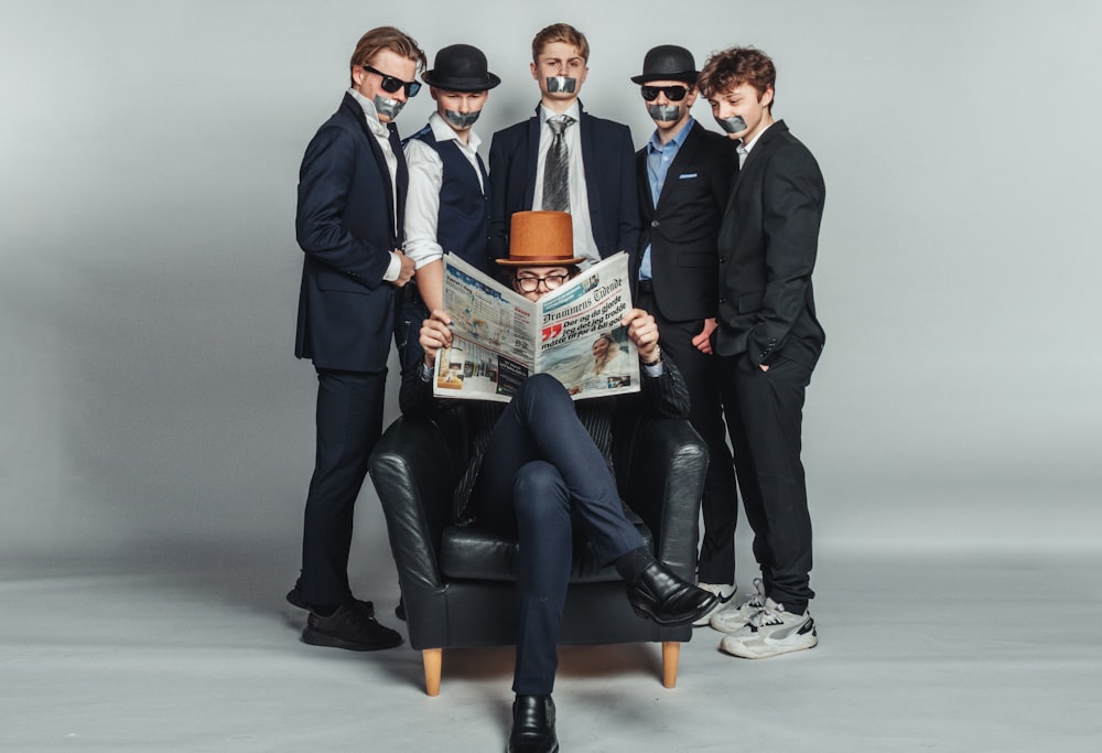 a group of men in suits and hats are posing for a picture