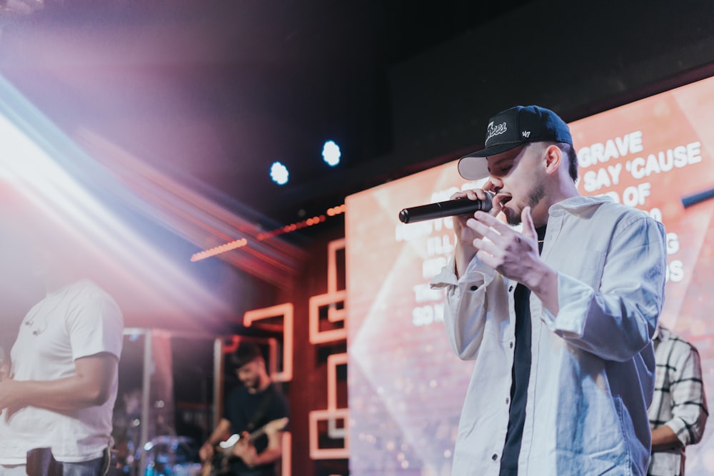 a man standing on a stage holding a microphone