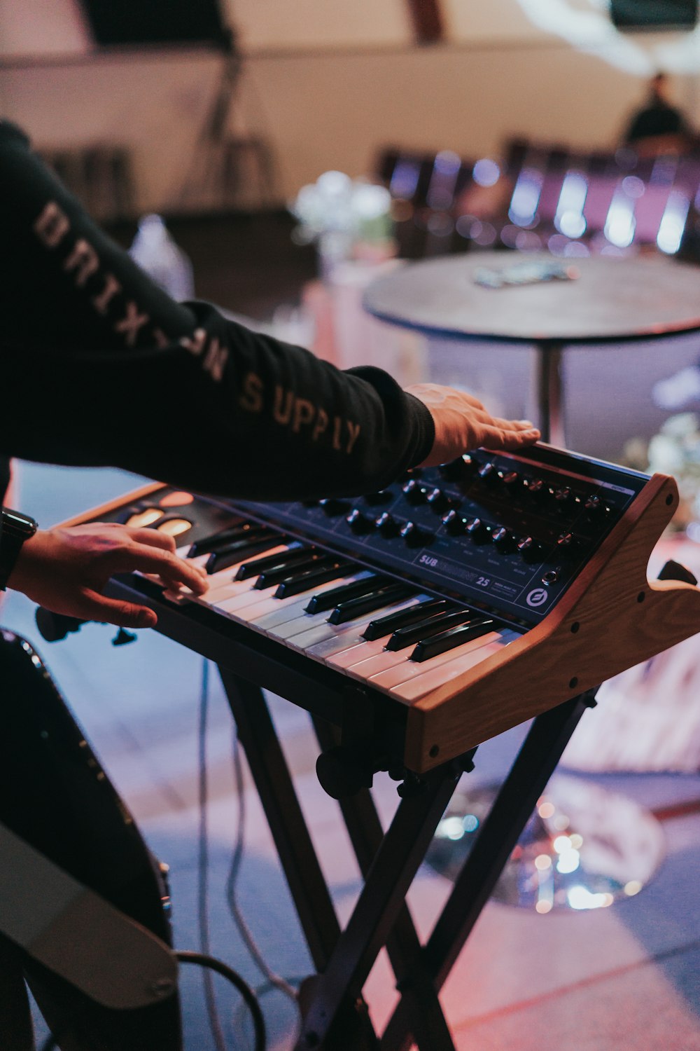 a person playing a musical keyboard in a room