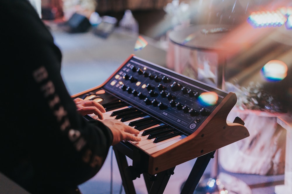 a person playing an electronic keyboard on a stage