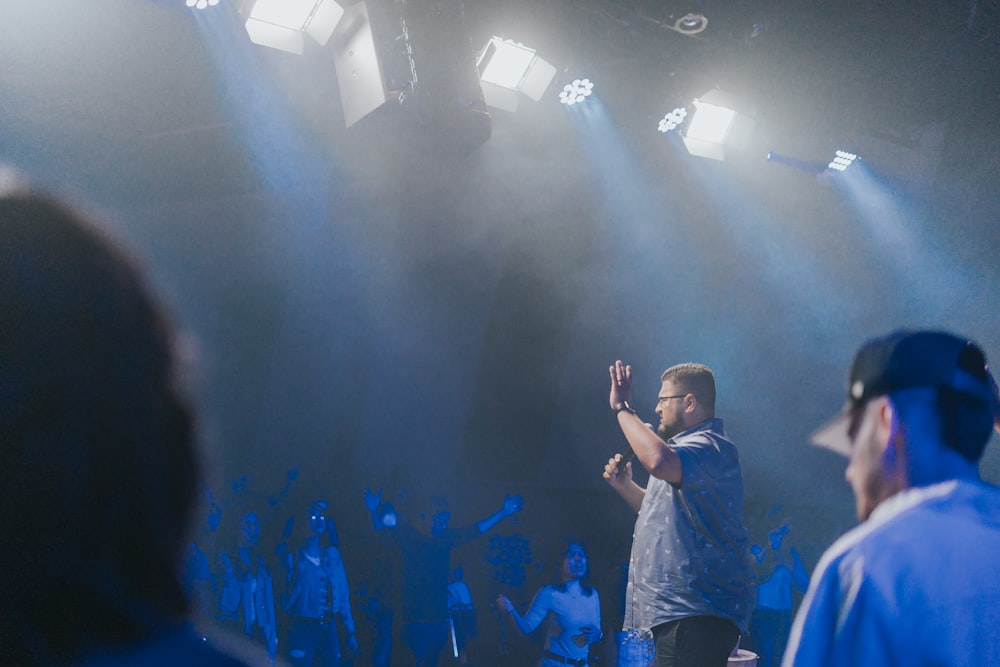 a man standing in front of a crowd of people