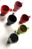A vibrant assortment of mugs in various styles and colors.