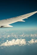 the wing of an airplane flying above the clouds