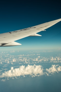the wing of an airplane flying above the clouds
