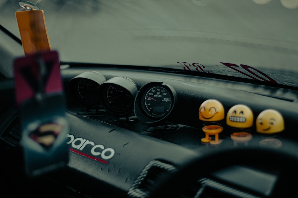 the dashboard of a car with smiley faces on it
