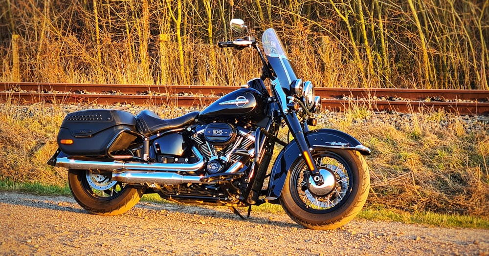 a black motorcycle parked on a gravel road