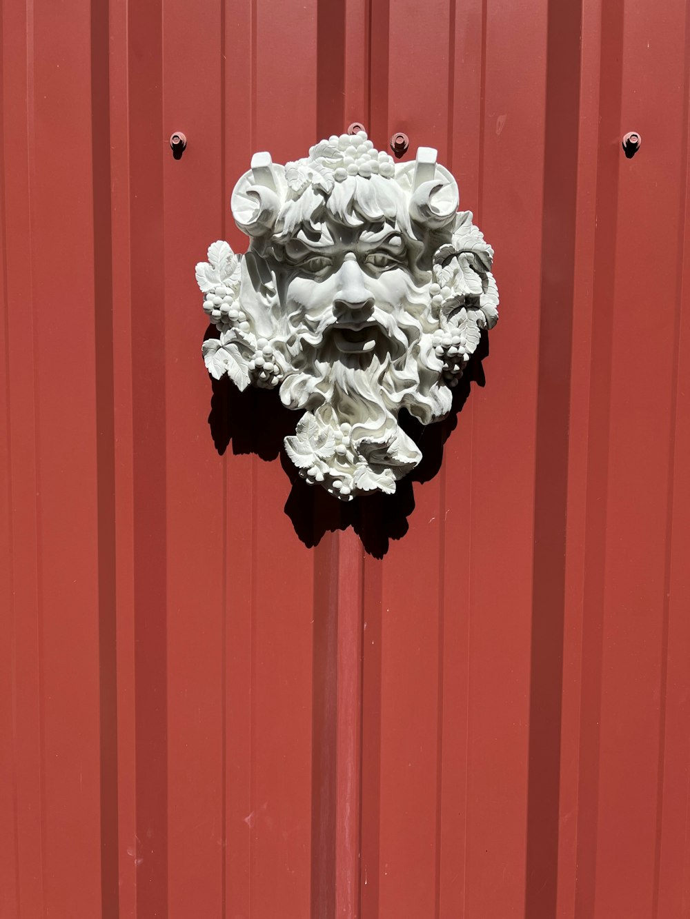 a red door with a white face on it