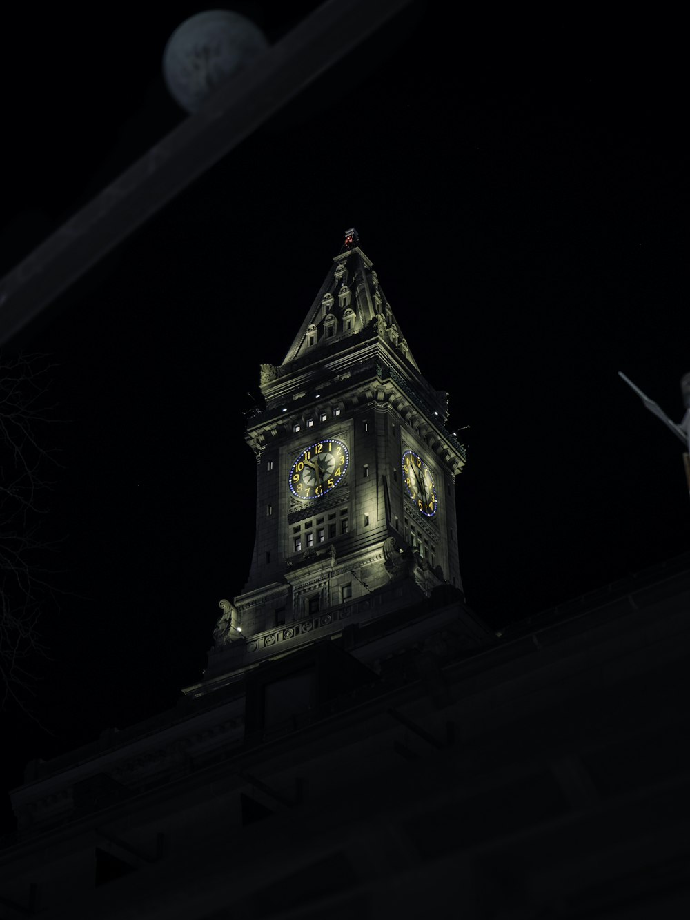 a large clock tower lit up at night