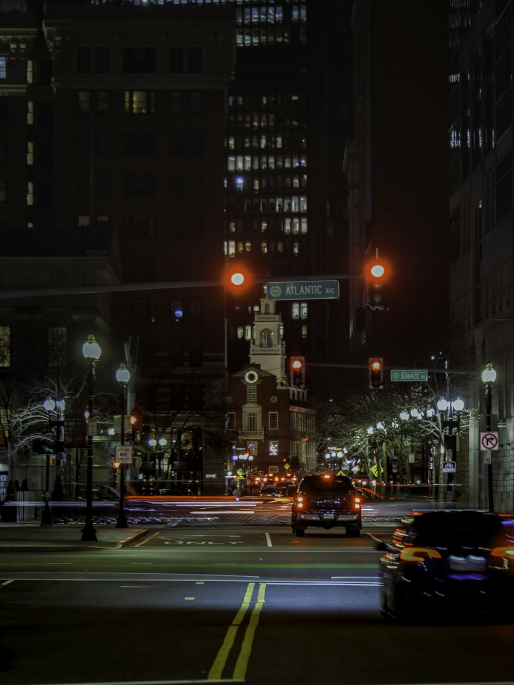 a city street at night with cars and street lights
