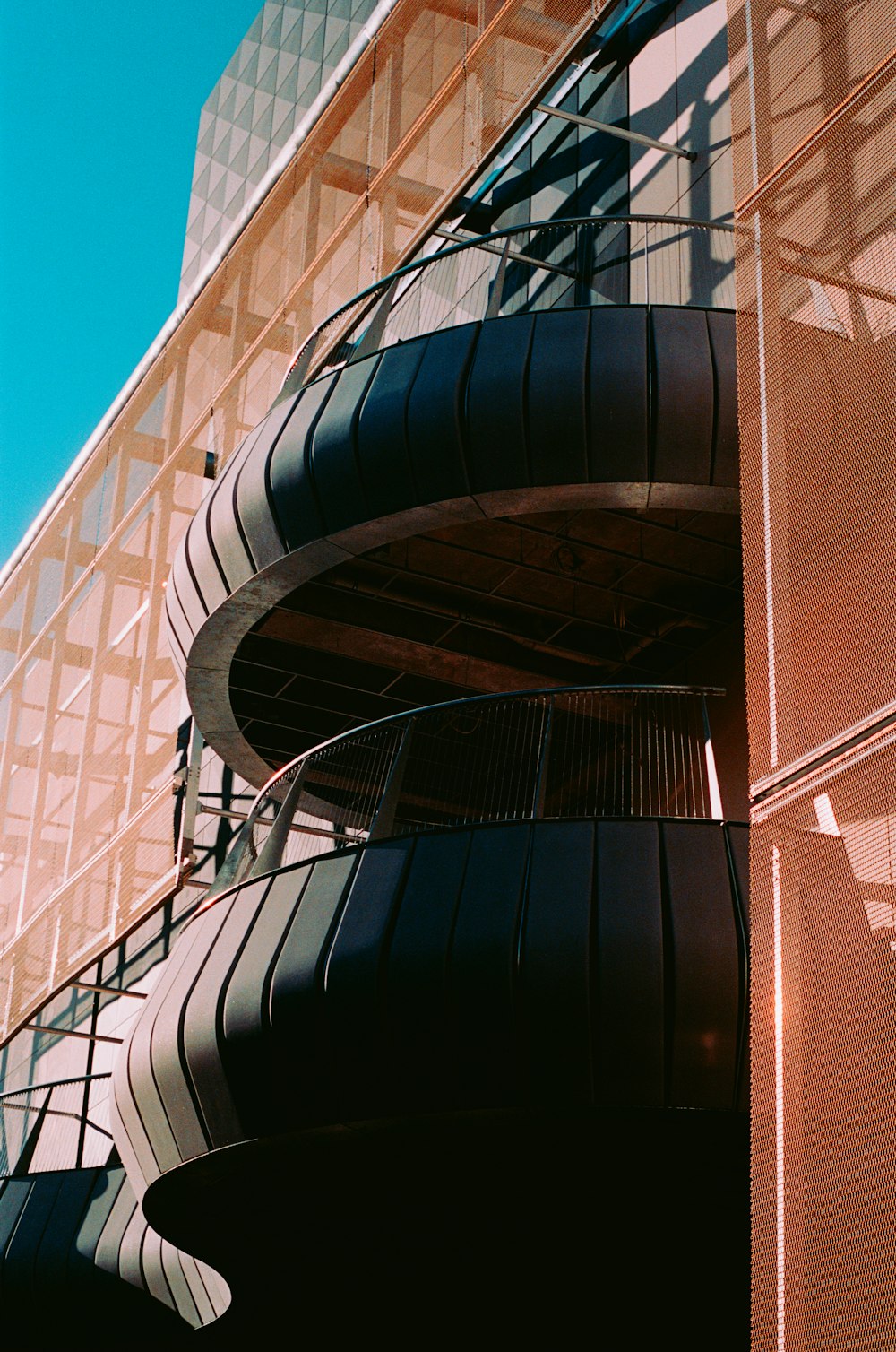 a tall building with a spiral staircase going up it's side