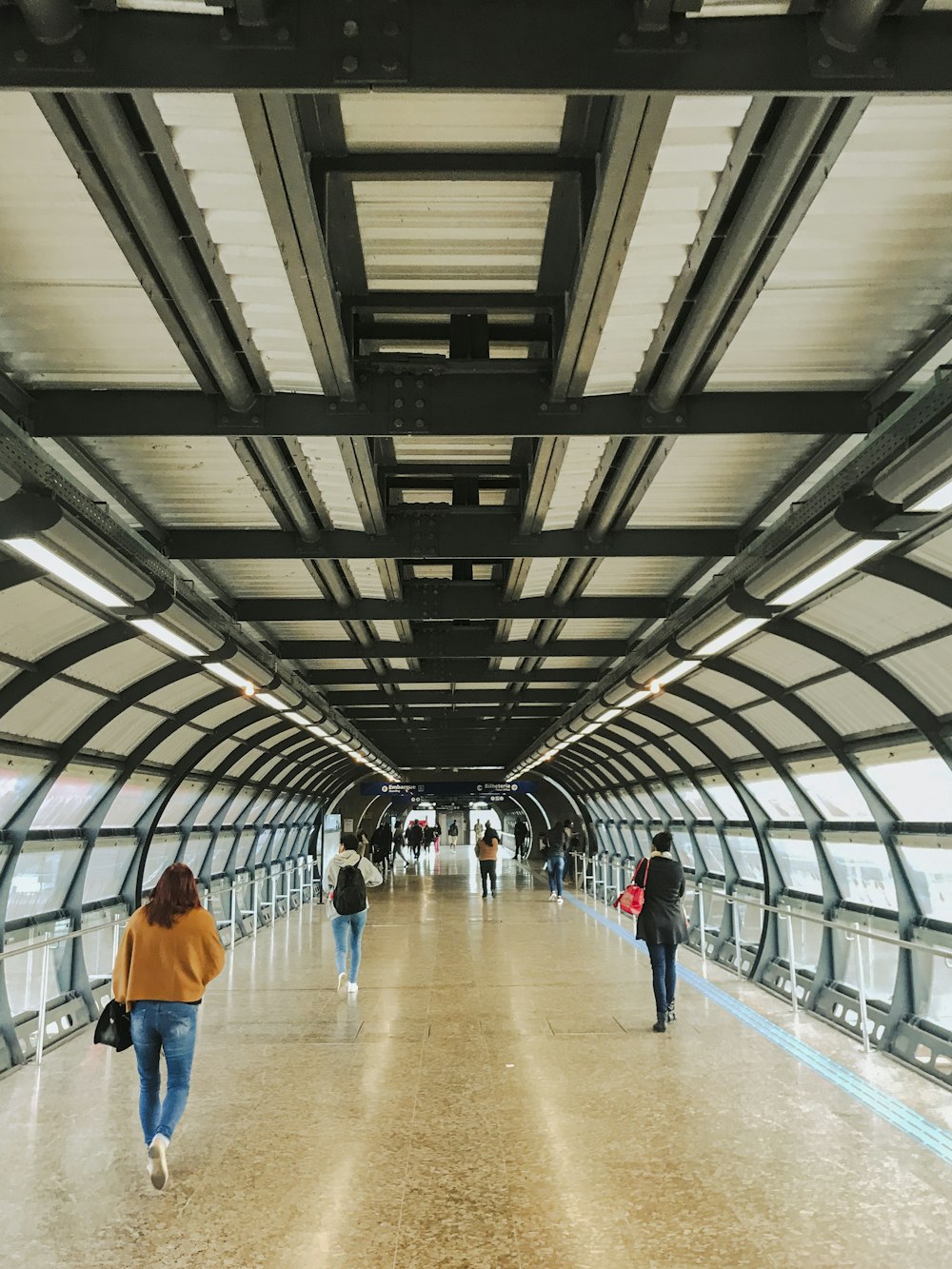 a group of people walking across a bridge