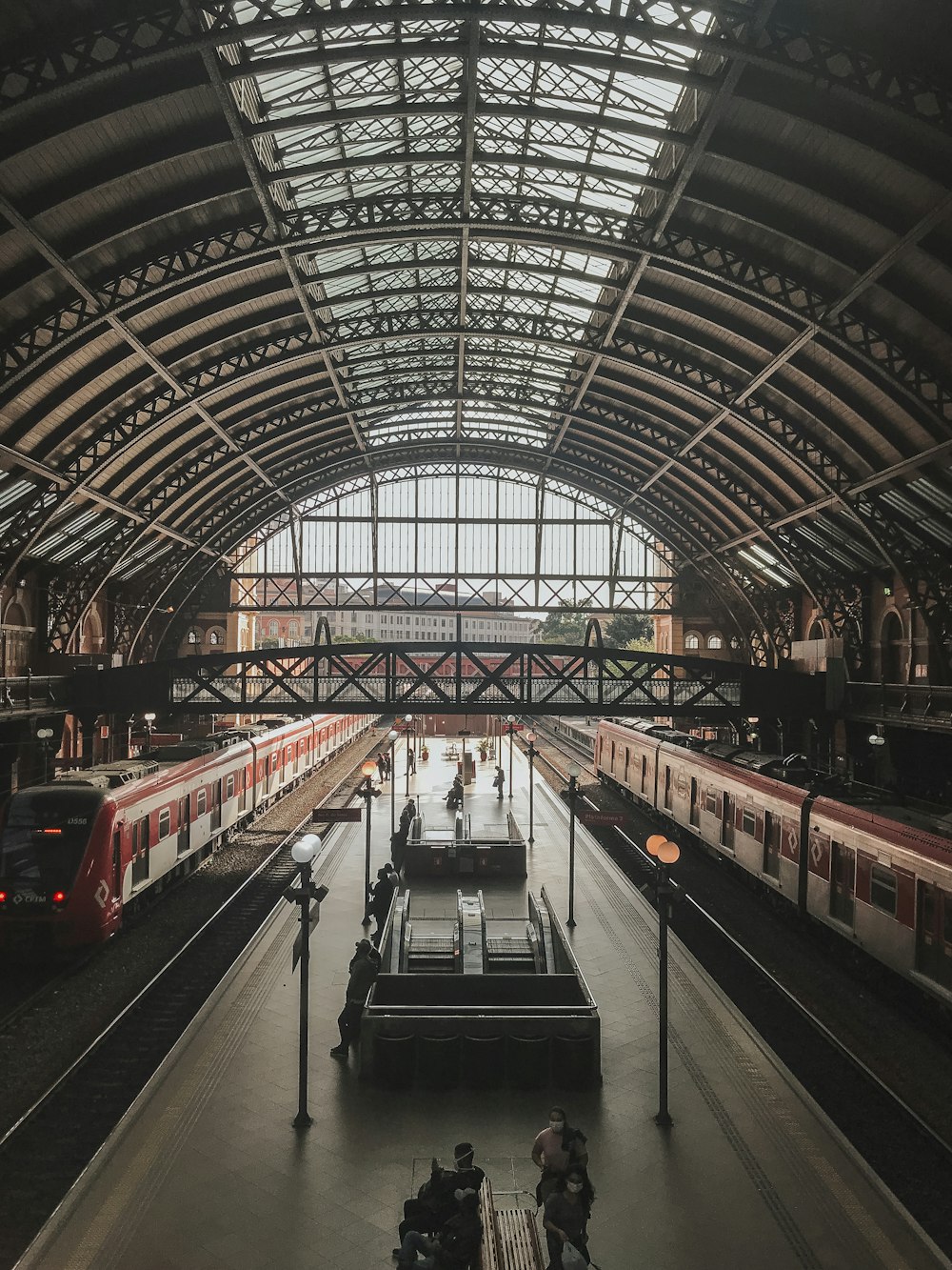 a train station with several trains parked inside of it