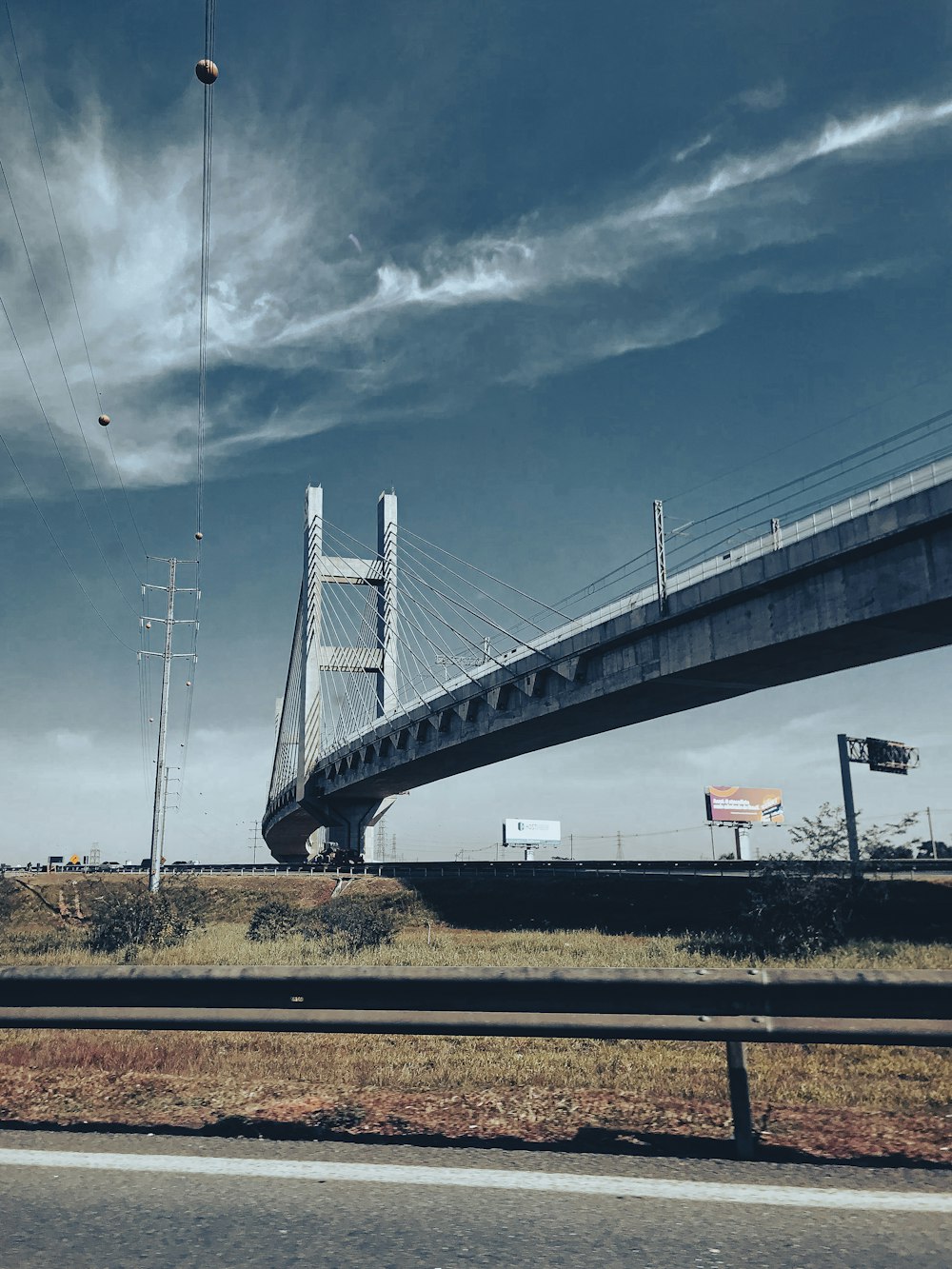 a view of a bridge from the side of the road