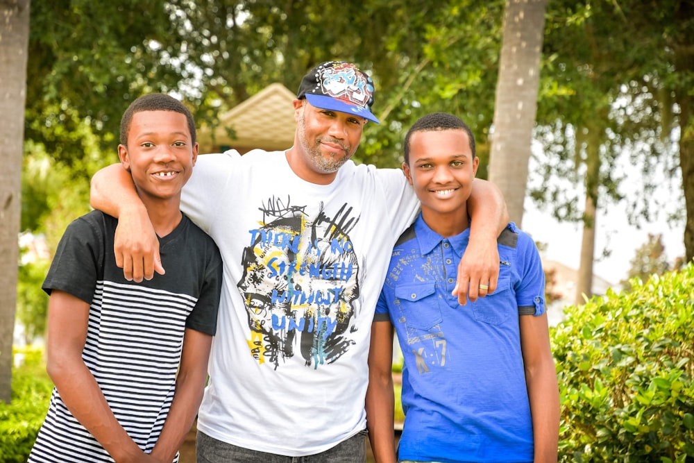 three young men standing next to each other