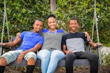 a couple of people that are sitting on a swing