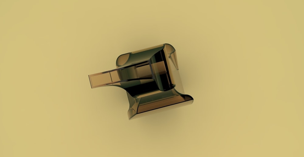 a metal object on a yellow background