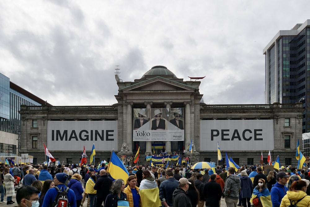 a crowd of people standing in front of a building